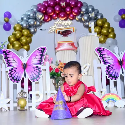A candid shot of the birthday girl exploring her party hat. I focus on capturing these natural moments that truly show the child's personality during their milestone first birthday celebration.