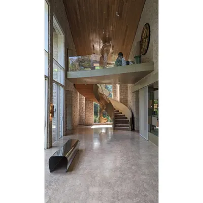 This is a bespoke installation in a private residence in Pune, created from cigarette butts and cane. The sculpture cascades down a spiral staircase, becoming an integral part of the home's architecture and daily flow of life.