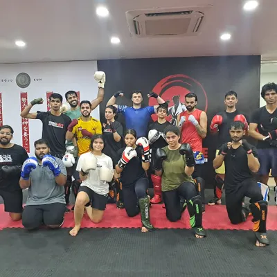 This isn't just a gym. This is family. A large group of our members posing together, showcasing the diverse and inclusive community we have built.