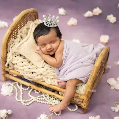 A sleepy smile from a tiny princess. Posing newborns on these miniature beds with soft fabrics creates such a dreamy and classic portrait.