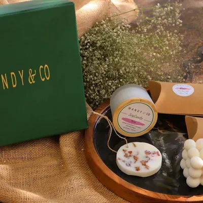 My "Radiant Diwali Treasures Gift Box," a luxurious collection to celebrate the festival of lights. It includes two artisanal soaps, a soy bubble candle, a scented soy candle, and a wax tablet.