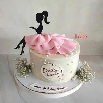 A pretty cake for the pretty woman in your life. This minimal-fondant design features an elegant silhouette topper with a flowing pink dress, perfect for a sophisticated celebration.