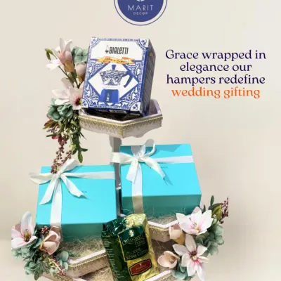 Grace wrapped in elegance. This multi-tiered hamper, adorned with soft florals, redefines wedding gifting by creating a stunning display for your precious presents.