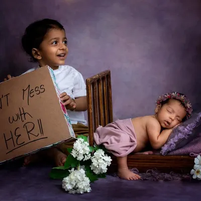 This big brother is already so protective! We had so much fun with this "Don't Mess With Her" sign. Including older siblings in a fun and playful way makes for such memorable photos.
