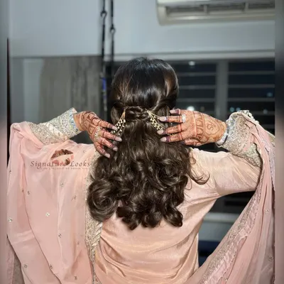 This back view shows the beautiful detail of the half-up style for a Roka ceremony. The hair is twisted neatly and secured with an elegant pearl hair accessory.