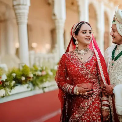 A candid moment between the bride and groom, sharing a glance after their wedding ceremony at a beautiful heritage location.