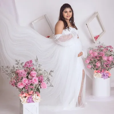 An angelic portrait in our all-white floral setup. We love creating a sense of movement by letting the sheer fabric of the gown float, adding to the dreamy feel.