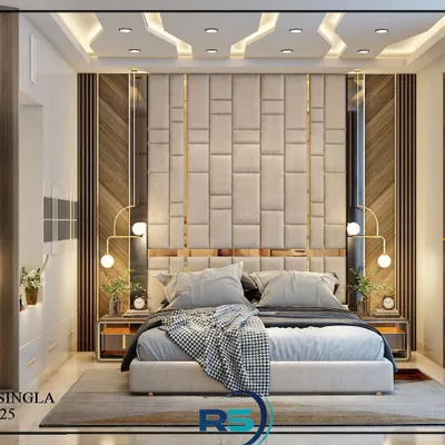 A master bedroom design featuring a floor-to-ceiling upholstered headboard with geometric patterns. The mix of wood paneling, mirror accents, and warm lighting creates a luxurious and inviting atmosphere.