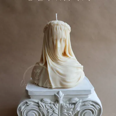This is my exquisite Veiled Lady bust candle, the star of the Olympia collection. Handcrafted from natural soy wax, its intricate details and French Vanilla scent make it a sophisticated work of art for your home.
