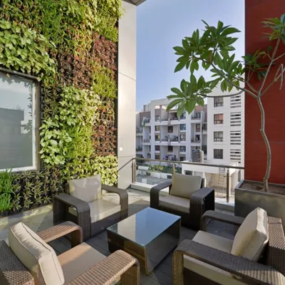 This terrace is an urban oasis, defined by its stunning living wall. We used a variety of plant species to create a rich tapestry of textures and colors, transforming a simple balcony into a vibrant green sanctuary.