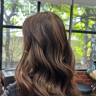 This is an example of a soft balayage I did. The hand painted highlights create a natural, sun kissed effect with beautiful dimension and soft waves.