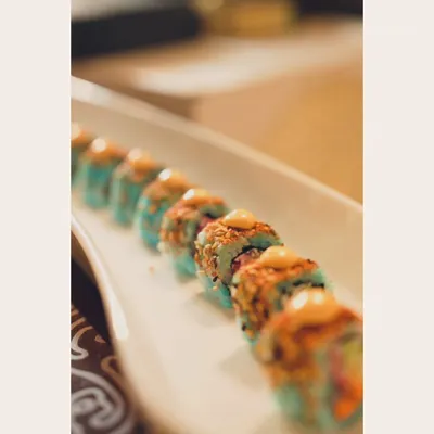Sushi, because it’s cheaper than therapy. A lineup of our colorful blue rice sushi rolls, beautifully plated and ready to be devoured.