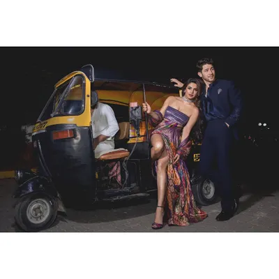 A confident and glamorous portrait of Priyanka Chopra and Nick Jonas. This shot, taken on the streets of Mumbai with an auto-rickshaw, blends high fashion with a distinctly local, candid energy.