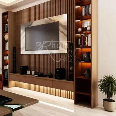 The centerpiece of the living room is this TV wall with vertical wooden fluting and integrated backlighting. This feature provides a warm, ambient glow and serves as a modern interpretation of the classic wooden interiors found in Kashmir.