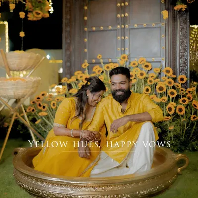 A sweet, posed moment before the Haldi fun begins. The sunflower decor and yellow outfits create a perfectly coordinated, joyful scene.