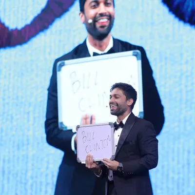 This is the moment of the big reveal. After a series of questions and interactions, I revealed the celebrity name an audience member was thinking of: Bill Clinton. The use of the big screen ensures everyone in the 500-person crowd shares in the astonishment.