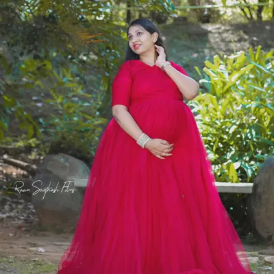 This simple yet stunning red flowy gown is perfect for a classic maternity portrait. The full tulle skirt provides a beautiful shape and a pop of color in a serene garden setting.