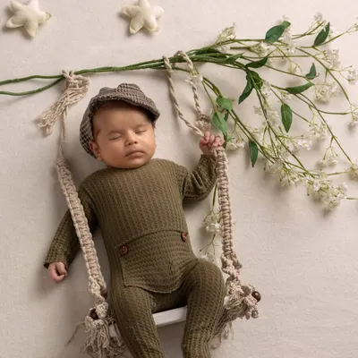 A dapper little gentleman. This peaceful, posed shot on a swing is a beautiful example of the artistic and creative portraits I love to create for newborns.