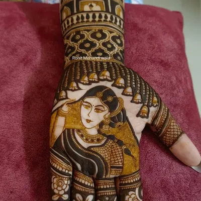 A close-up view of my portrait work. You can see the fine details in the bride's face, jewelry, and saree, all drawn carefully with a henna cone to create a realistic and beautiful image.