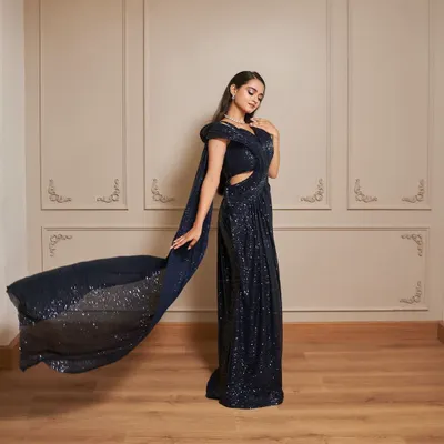 Our Glamour gown is a showstopper. This navy blue sequined dress features a thigh-high slit and a dramatic, flowing trail for a red-carpet-worthy look.