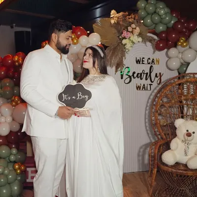 Capturing the fun and excitement of a baby shower event. This photo shows the happy couple amidst their themed decorations, a wonderful memory of the celebration before the baby's arrival.