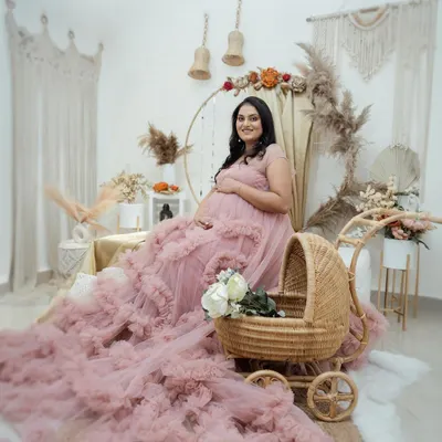 This wide shot shows the complete boho-chic setup in my studio. The combination of the ruffled gown, wicker pram, and macrame hangings creates a beautifully textured and inviting scene.