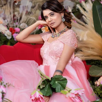 A dreamy shot of the pink princess ball gown, featuring a textured bodice and a multi-layered tulle skirt.