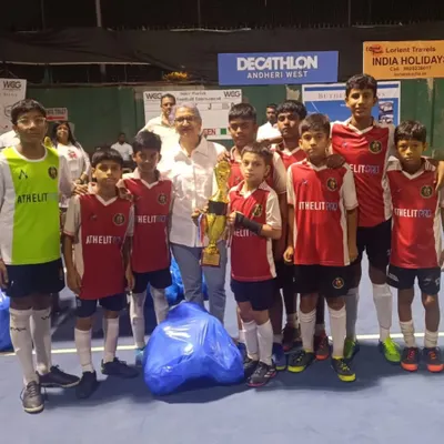 Our U13 team after a tournament, showcasing their medals and trophy.