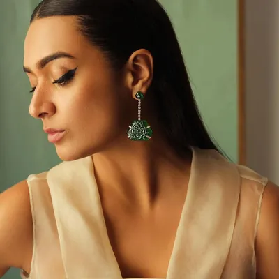 A close-up on these magnificent carved emerald and diamond earrings. This showcases my focus on finding unique, art-deco inspired pieces that become conversation starters.