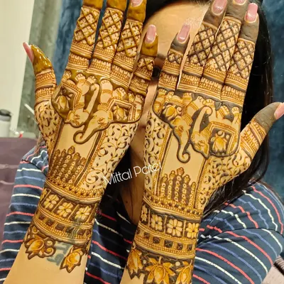 A heavy and intricate back of hand design featuring majestic elephants. The dense patterns and bold motifs create a royal and unforgettable look, perfect for a bride.