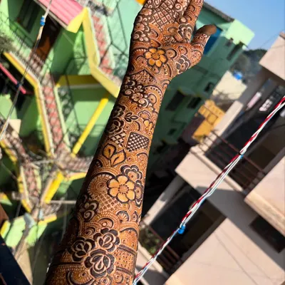 A beautiful floral arm design captured in the sunlight, showing the rich color and intricate details of the flowers and leaves.