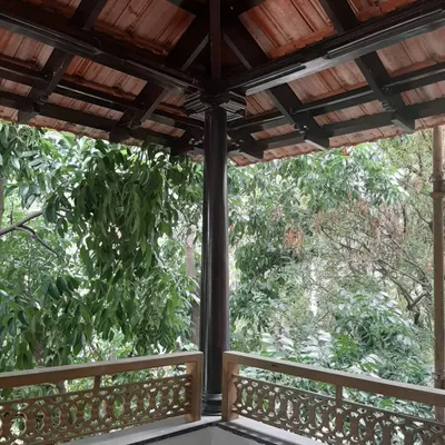 This image captures the restoration of a traditional balcony. We preserved the original sloping tiled roof, dark wood pillars, and intricately carved wooden railings, maintaining the authentic charm of the space while ensuring its structural integrity for years to come.
