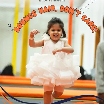 "Bounce hair, don't care" is the motto in our trampoline park. This little girl in her party dress is having the time of her life, and her smile says it all.