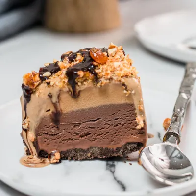 The heart of our craft shown in a single slice. See the distinct, delicious layers of ice cream and cake that make our signature ice cream cakes an unforgettable experience.