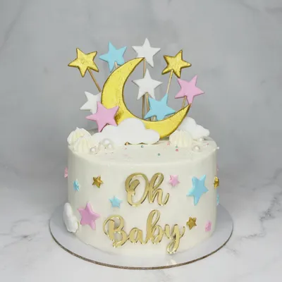 "Oh Baby!" This sweet baby shower cake is decorated with a moon and stars theme, featuring custom gold toppers and pastel-colored star accents. It's a dreamy centerpiece for welcoming a new arrival.