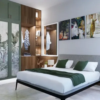 This bedroom design combines serene green and natural wood tones. The wardrobe features custom-printed doors, and an open-shelf section provides a space for personal display, creating a room that feels deeply personal and comfortable.