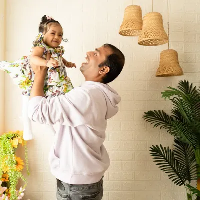 A candid, joyful moment between a father and his daughter. These unposed shots are often the most powerful, capturing the pure love and connection within a family.