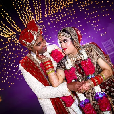 A romantic couple portrait against a backdrop of sparkling fairy lights. We use creative lighting to create a magical and dreamy atmosphere for your wedding photos.