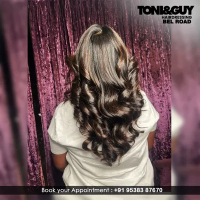 This is how we bring glamour to long hair. We created deep, uniform curls to give this client's hair incredible volume, shine, and a perfect special-occasion style.