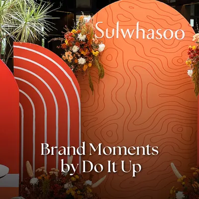 A custom backdrop for the Sulwhasoo launch, featuring their signature orange and topographic patterns to reflect the brand's connection to heritage and natural ingredients. This is a key element in our brand activation pop-up designs.