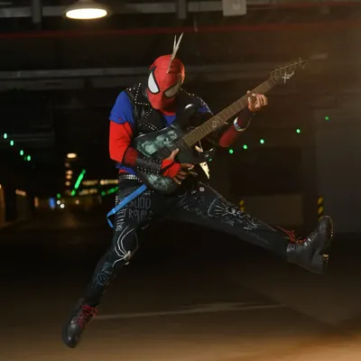 An action shot of my Spider-Punk cosplay. I made the entire suit, including hand-painting the details on the pants and weathering the jacket and guitar.