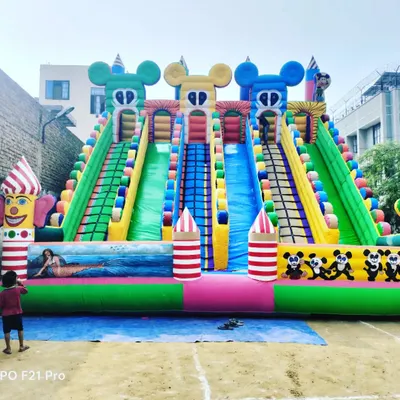 A massive 6-slider bouncy castle with a fun Mickey and clown theme, shown here ready for delivery. The multiple lanes are great for handling crowds at large fairs and amusement parks.
