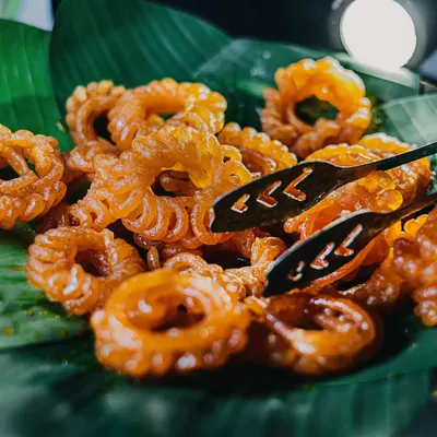 Taking the phrase "kuch meetha ho jaaye" very seriously. A platter of hot, crispy imartis, a classic Indian sweet, served fresh on a banana leaf for an authentic touch.