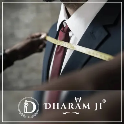 The journey to a perfect suit starts with the right measurement. Here, I am ensuring every detail is captured for a flawless fit.