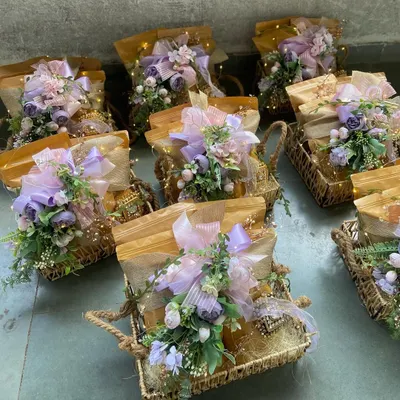 A beautiful array of our custom hampers, each featuring a soft lavender floral theme and illuminated with delicate fairy lights. These are perfect for bulk orders for weddings or corporate events, ensuring every guest receives a memorable and elegant gift.