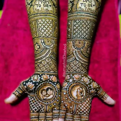 A classic and intricate baby shower henna design. This set includes "Mom to be" and "Dad to be" text on the forearms, with detailed portraits of the family on the palms, all tied together with traditional jaali and floral patterns.