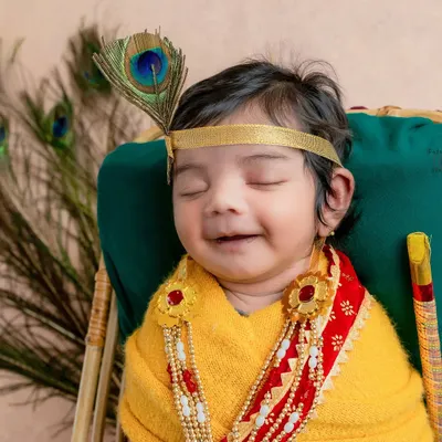 My heart melts seeing a baby dressed as Natkhat Krishna. This little one's peaceful smile, complete with a peacock feather, captures the divine and playful spirit of the theme.
