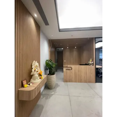 The entrance to our new Pune office, featuring our ARH brand identity at the reception desk. The space is designed with light wood tones and clean lines, including a dedicated niche for a Ganesha idol to welcome positive energy.