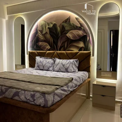 A master bedroom we designed to be a true sanctuary. The arched feature wall with botanical wallpaper, integrated backlit mirrors, and a custom upholstered bed come together to create a cozy, elegant space.