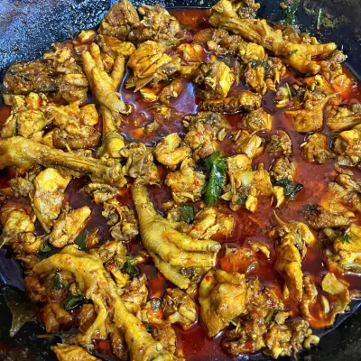 A luscious country chicken curry, cooked with bones and chicken feet for maximum flavor, just like at home.